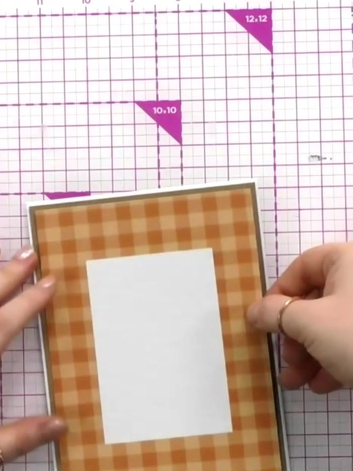 Step 3: Select one of the decorative patterned boards from the kit. Adhere it to the front of your orange gingham card
