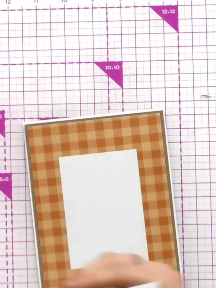 Step 4: Trim a second piece of the orange gingham patterned paper slightly smaller than the first to create a matting 