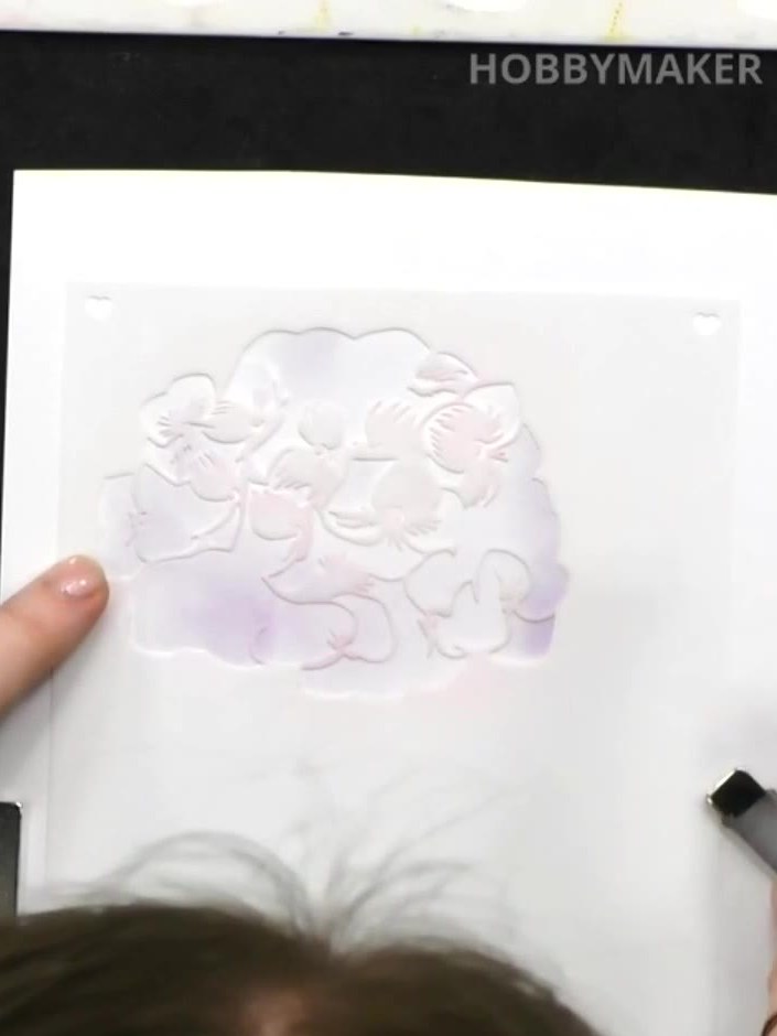 Step 2: Apply pale purple ink through the stencil using a dauber, working gently to create a soft background pattern o