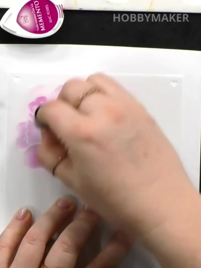 Step 3: Use a dabber to apply pink ink through the stencil, focusing on the small island element in the centre. Dab ge