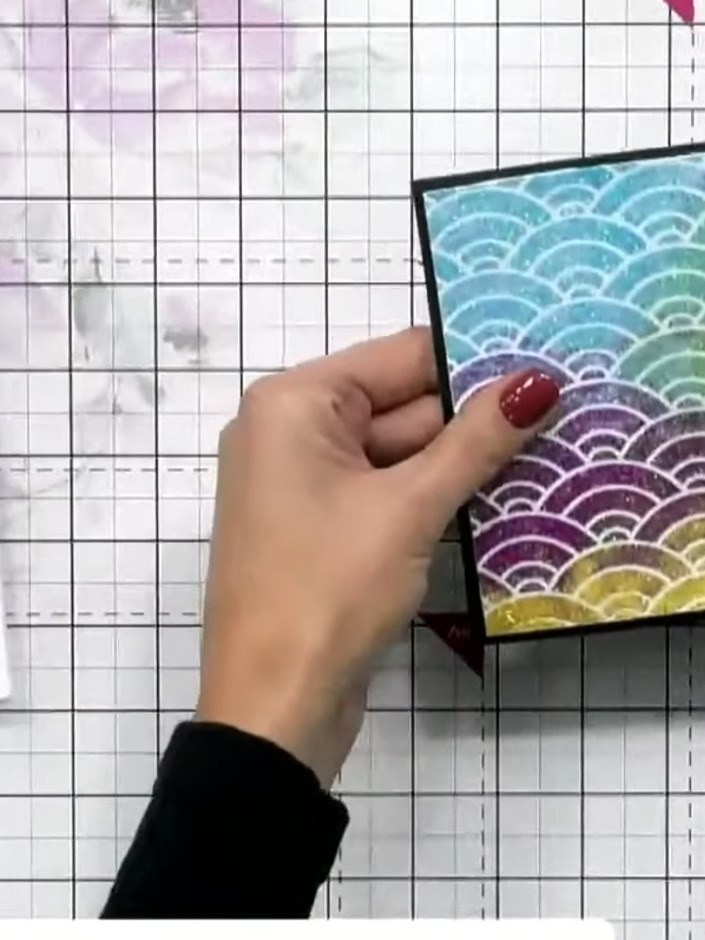 Step 3: Tape the vellum piece with the rainbow scallop pattern to a piece of black cardstock to create your base layer