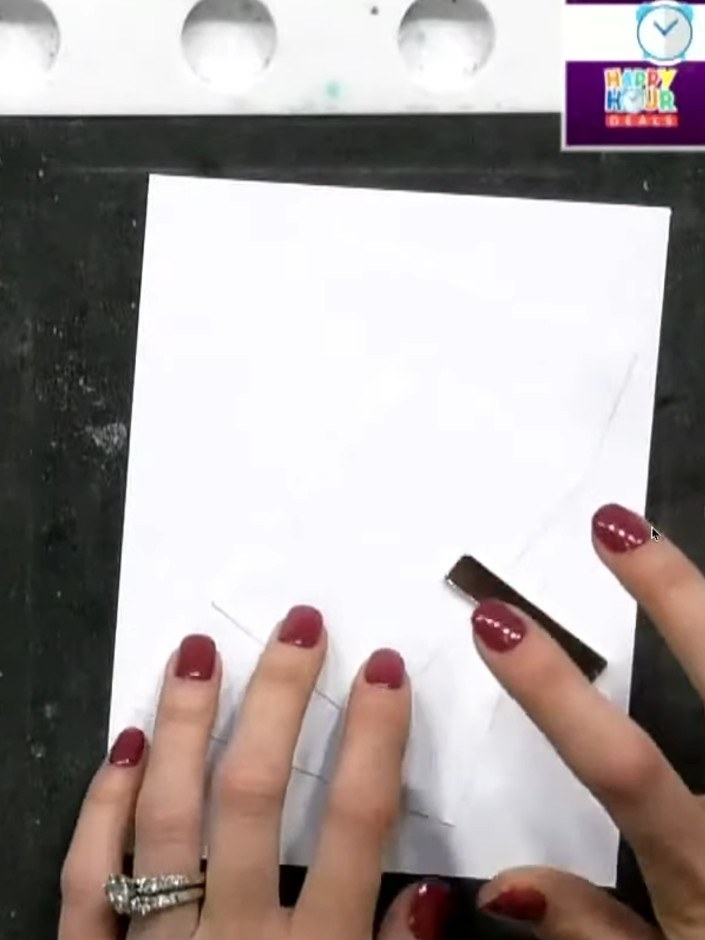 Step 1: Position three pieces of white cardstock on your black mat at a slight angle. Tape them down to secure them in