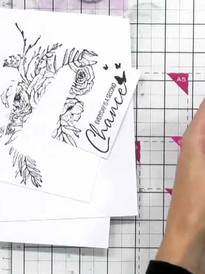 Step 5: Layer the stamped floral piece on top of the purple card base using foam pads to create dimension.