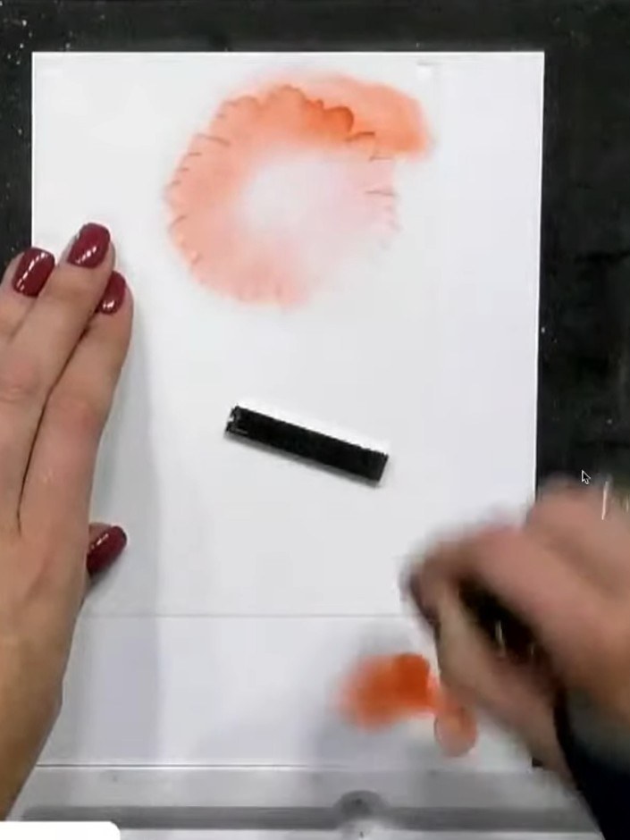 Step 4: Position stencil two over your card and apply pink ink through the stencil using a blending brush. Build up th