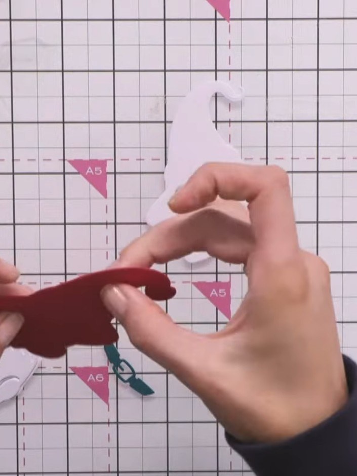 Step 7: Glue the two red gnome halves together at the fold, keeping them flush and aligned. Repeat with the white gnom