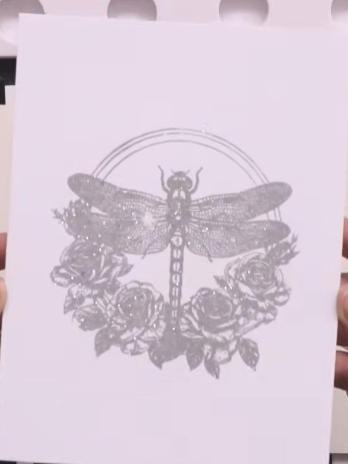 Step 5: Once the embossed dragonfly has cooled, use the coordinating die to cut around the stamped image, creating a s
