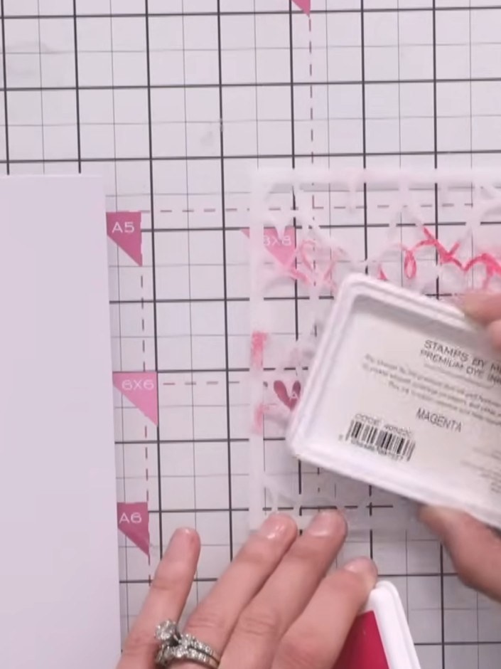 Step 6: Ink up the heart stencil with magenta ink directly on the stencil itself. Add touches of orange and teal ink t