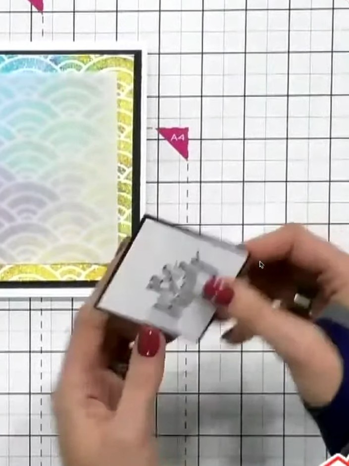 Step 6: Apply foam pads to the back of the black card frame that will sit over the glittered stencilled panel.