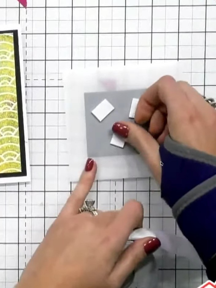 Step 7: Adhere the raised glittered element to the centre of the vellum card front using foam pads. Position it carefu