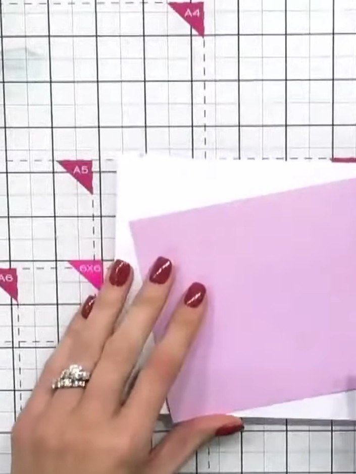 Step 1: Select a cool pink textured linen cardstock from the pastel collection. Fold it in half to create your card ba