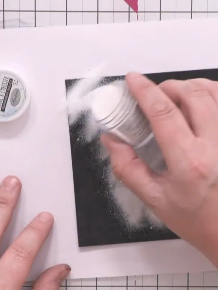 Step 4: Sprinkle clear sparkling embossing powder over the black inked design, ensuring the entire stencilled area is 