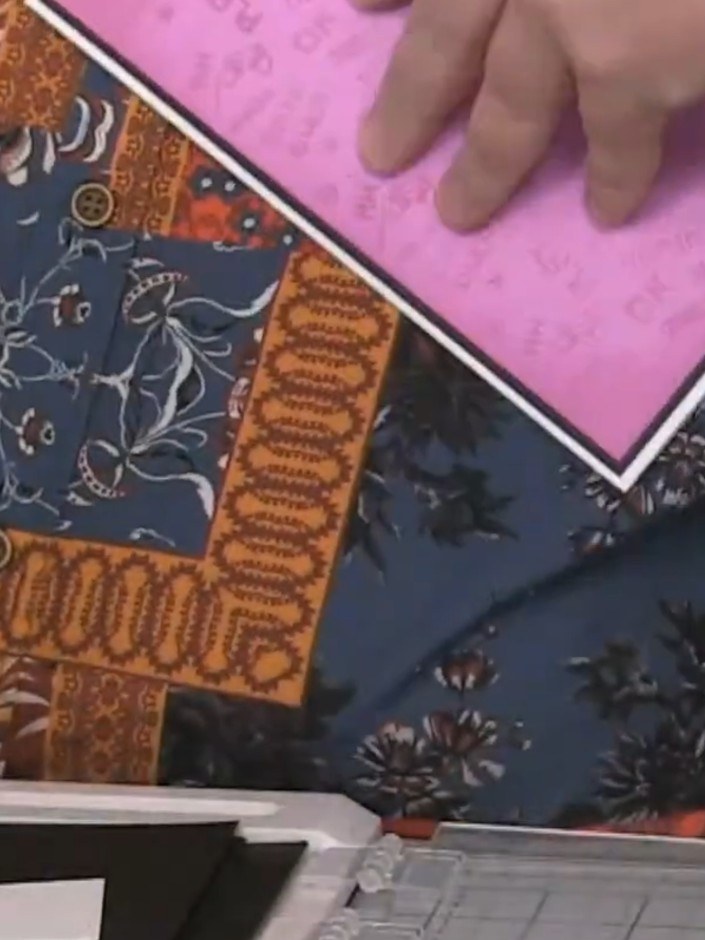 Step 1: Create the card base with a pink background panel. Use nesting dies to cut black and white layered frame eleme