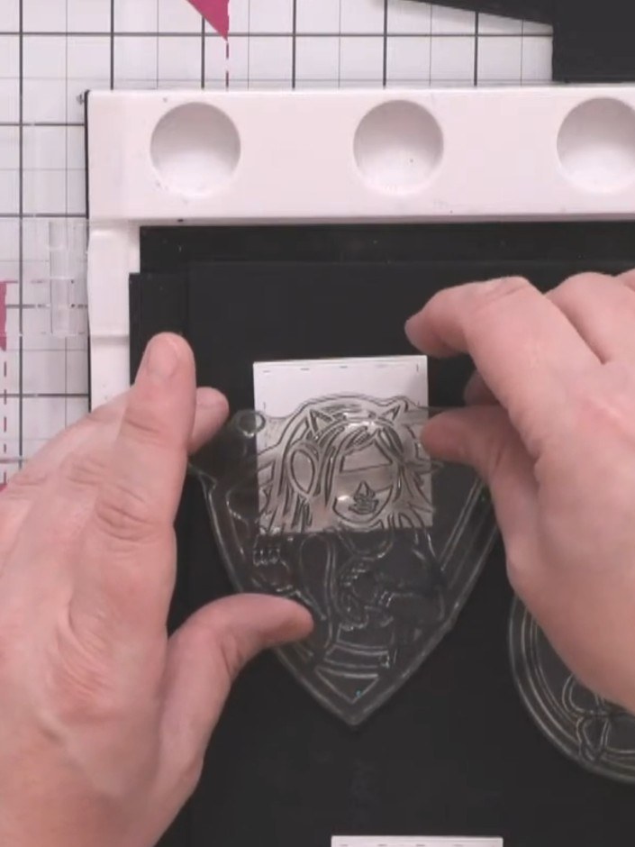 Step 2: Position the male character stamp in the upper portion of the card front. The stamp shows a character in a shi