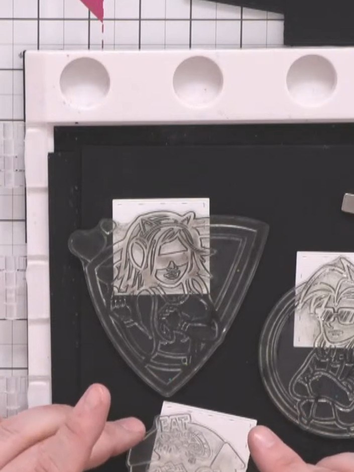Step 3: Position the female character stamp (circle design) next to the male character stamp on your black cardstock, 