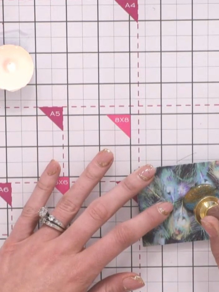 Step 4: Pour the melted wax from the spoon onto your chosen location on the decorative paper to create a small blob. T