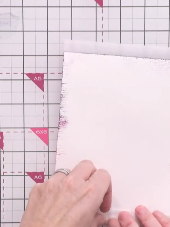 Step 10: Apply adhesive to only the top and bottom edges of the vellum overlay. Adhere the vellum to the back of the sp