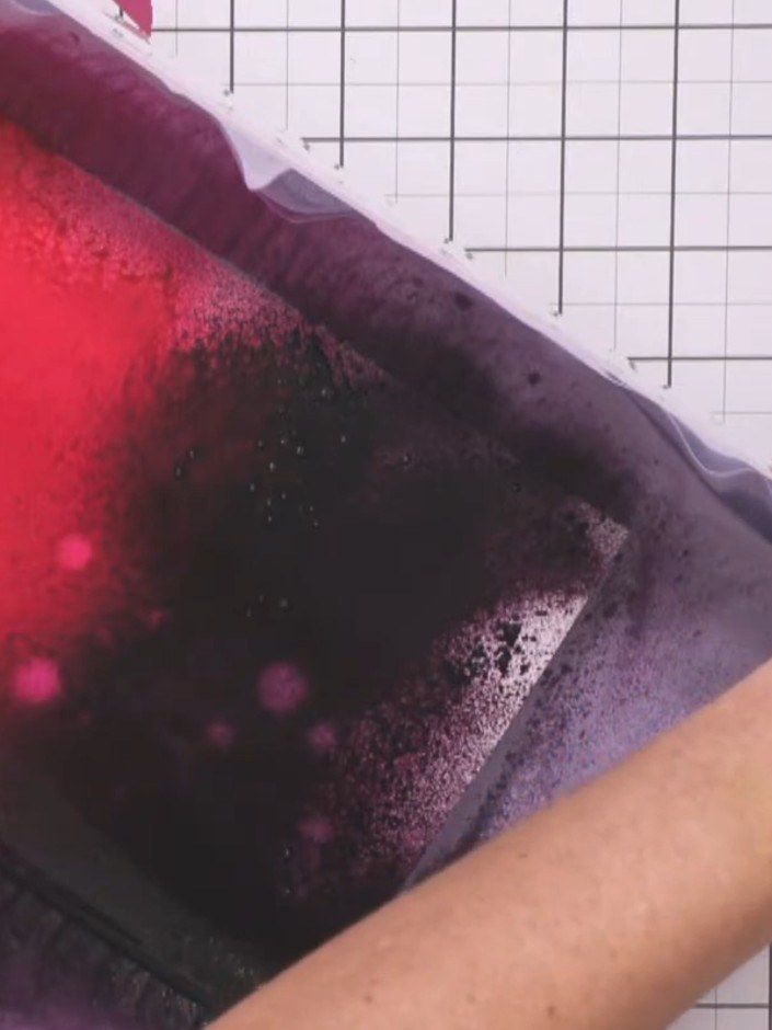 Step 3: Spray the black currant purple intense diamond ink across the bottom and middle sections of the vellum, allowi