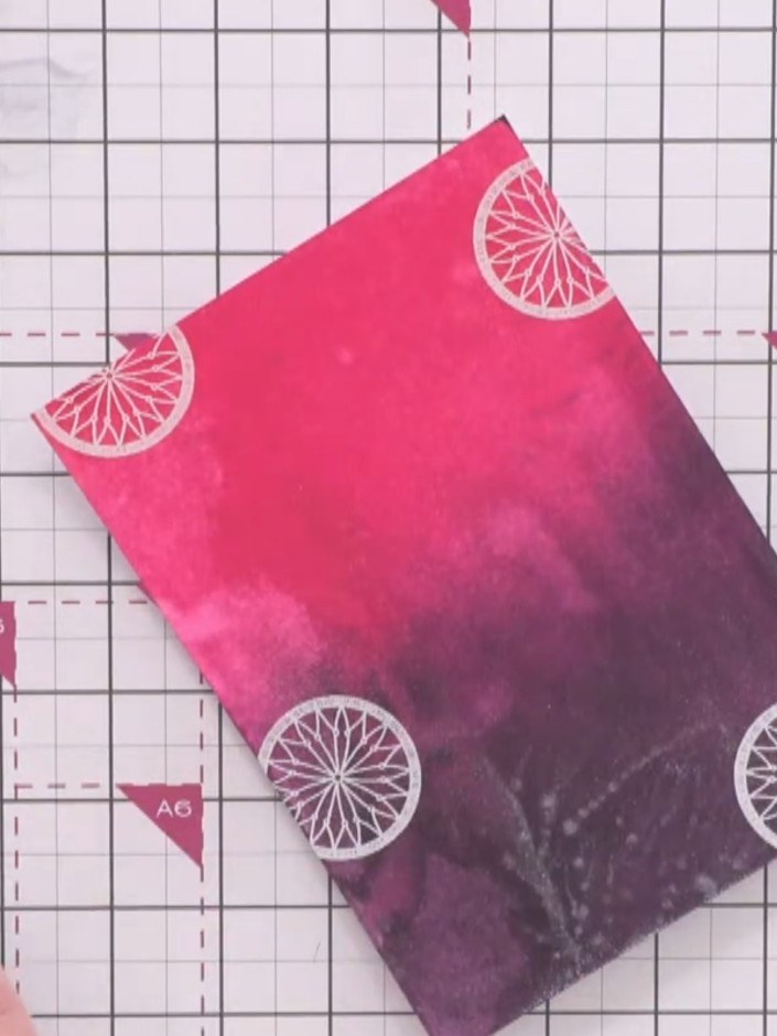 Step 6: Stamp feather and bead elements from the A6 stamp set around the background, tessellating them to create suppo