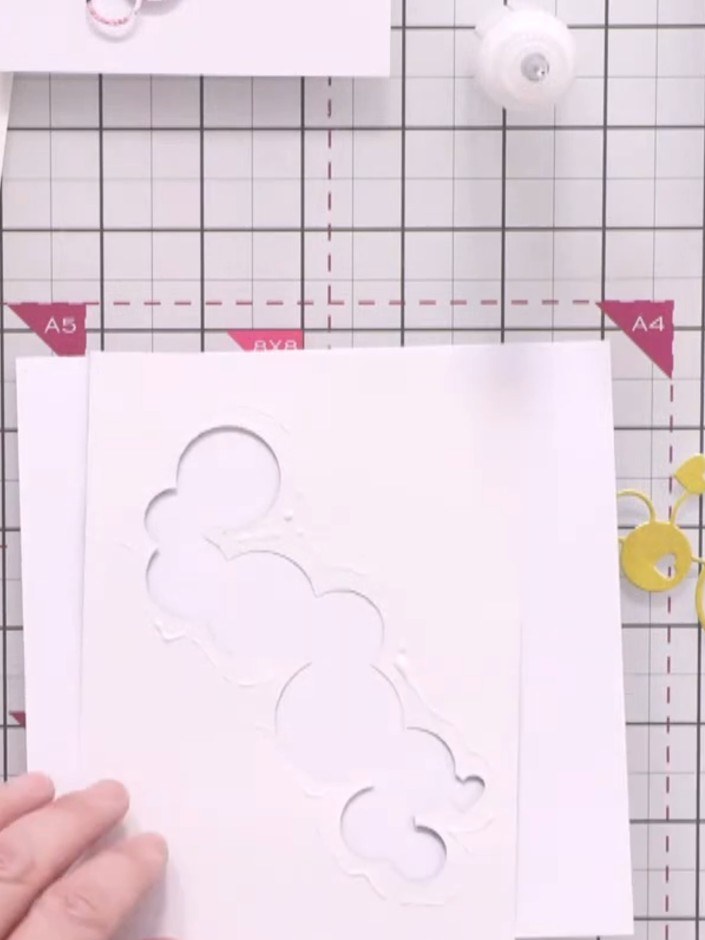 Step 2: Apply adhesive carefully around the edges of the die-cut aperture on the reverse side of the card front. Posit