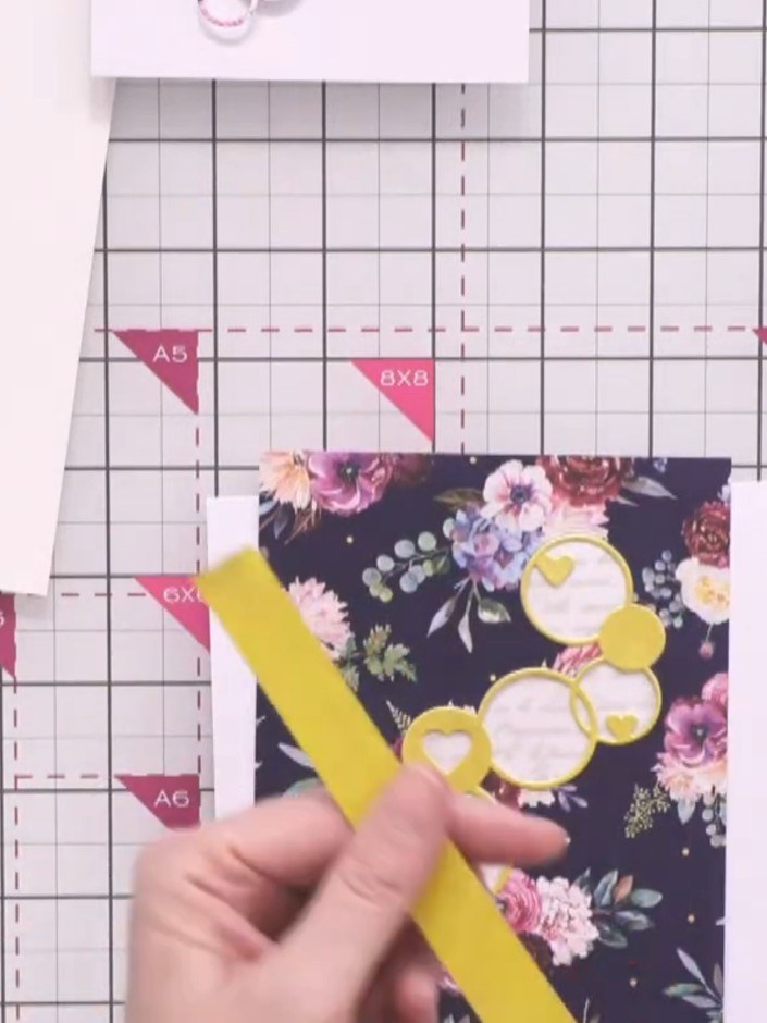 Step 5: Cut strips of gold cardstock and adhere them around the edges of the aperture panel to create a mat frame. Pos