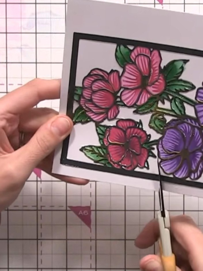 Step 10: Carefully cut around the die-cut flowers with scissors to separate them from the plate format. Trim away any u