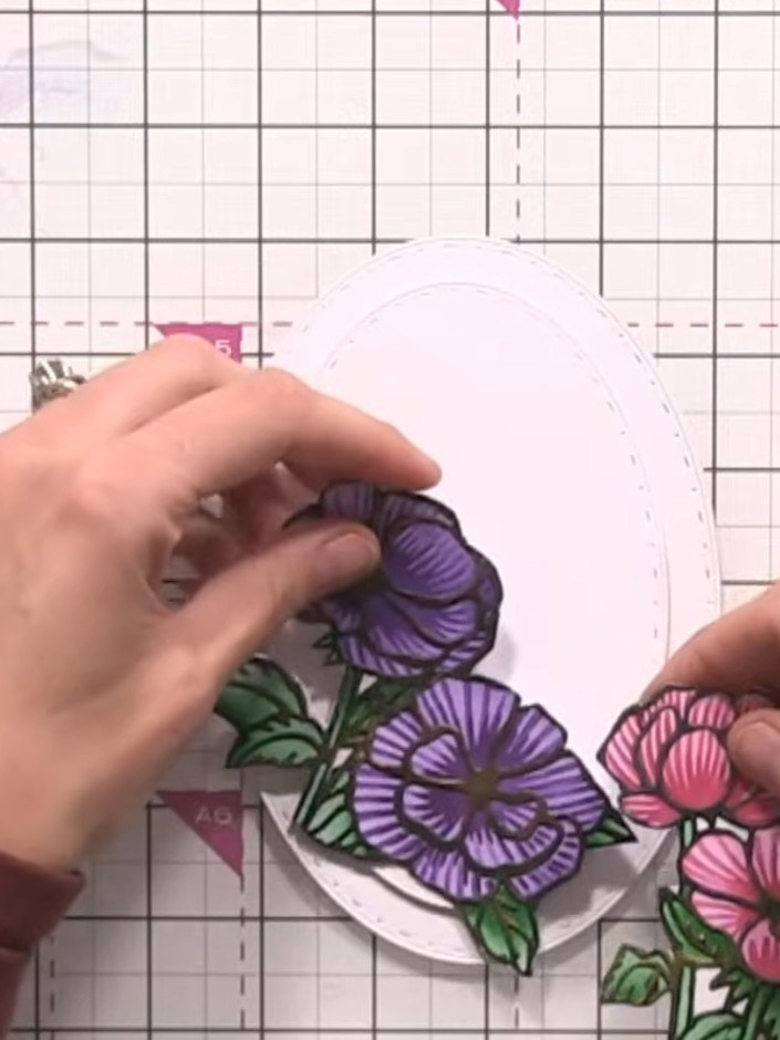 Step 16: Arrange and adhere the padded flower pieces onto the front of your oval card, building up a dimensional floral