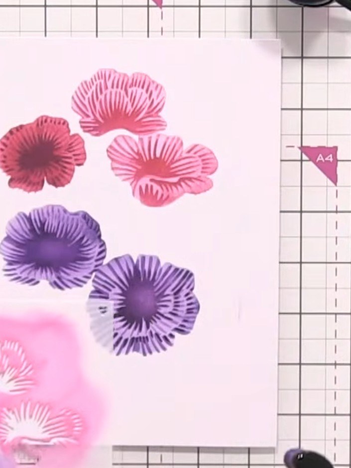 Step 5: Apply the green ink through the fourth stencil layer to add the foliage details to your flowers. Keep the gree
