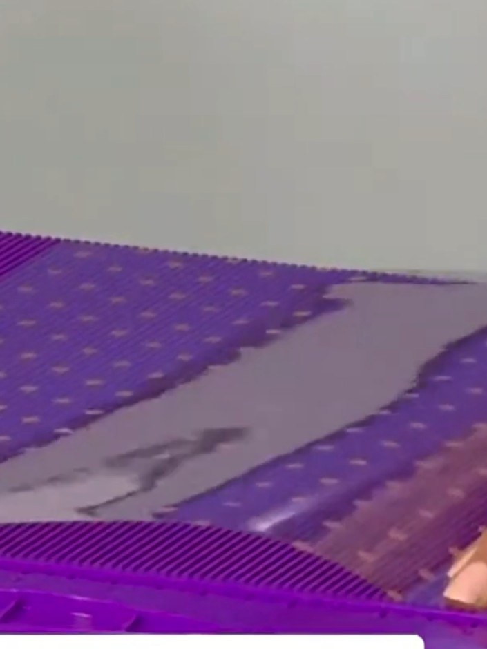 Step 2: Cut off approximately two inches from one end of the purple acetate sheet to create the base piece.
