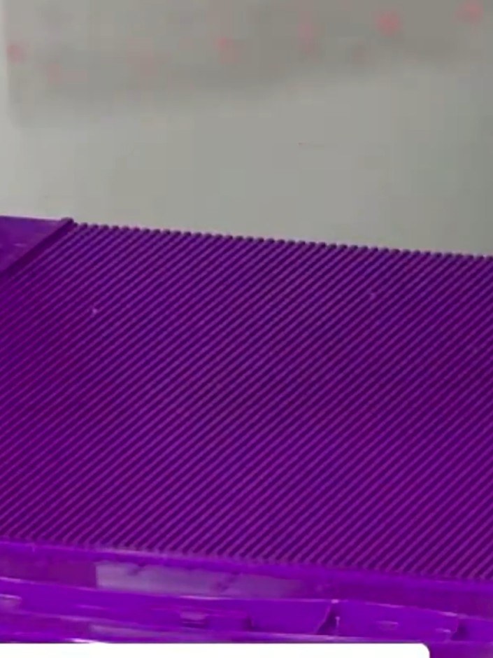 Step 4: Score at half an inch on the bottom edge of the purple acetate sheet.