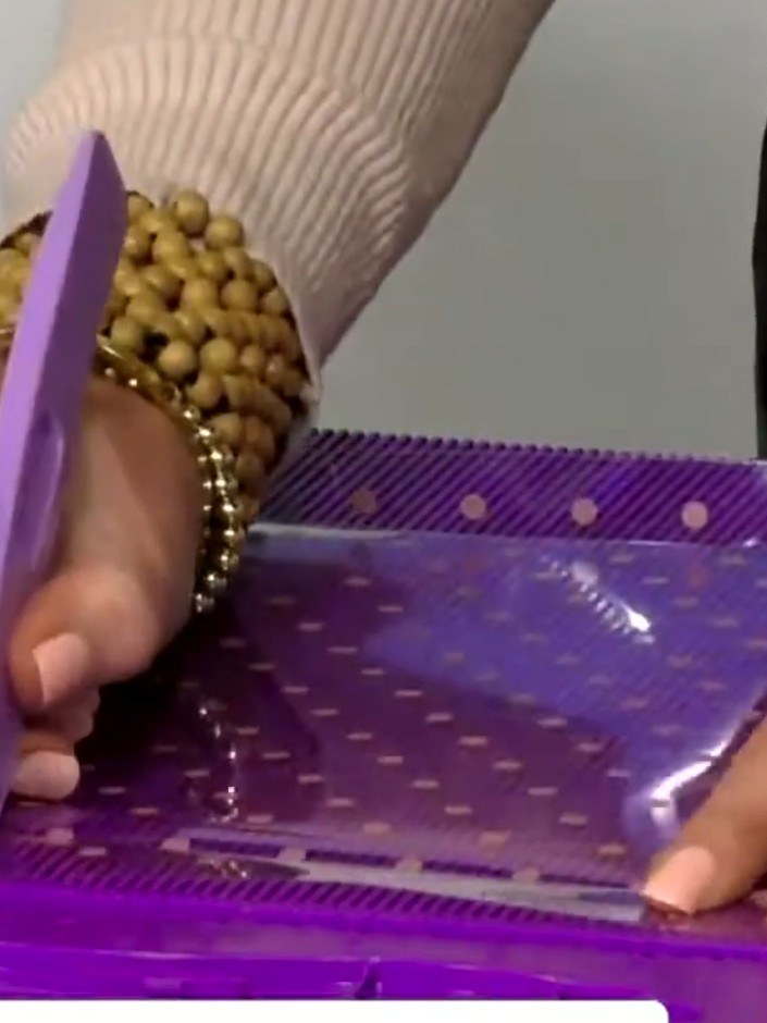 Step 6: Score the purple acetate at eight inches on the same side to create panel divisions.