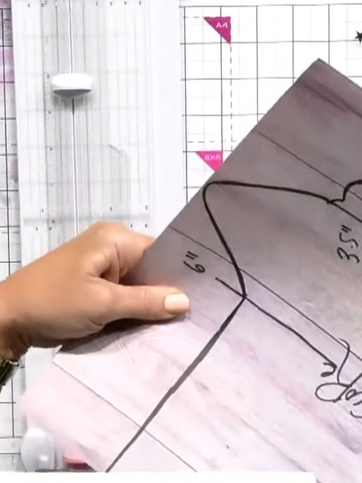 Step 5: Fold a piece of vellum in half to create a signature. Secure the folded vellum with elastic cord threaded thro