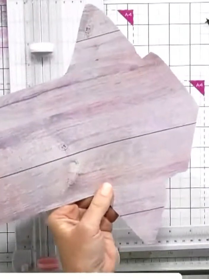 Step 6: Thread elastic through the scored signature fold, creating a double loop that will serve as the binding mechan