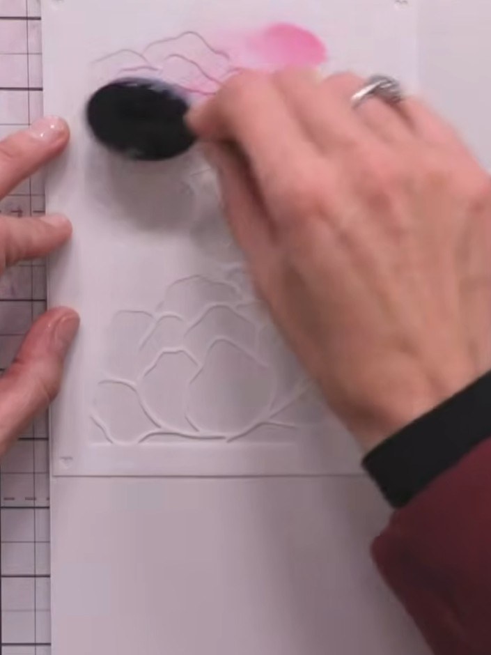 Step 2: Using a blending brush, apply Fandango ink from the magenta ink pad to the top flower section of the embossed 
