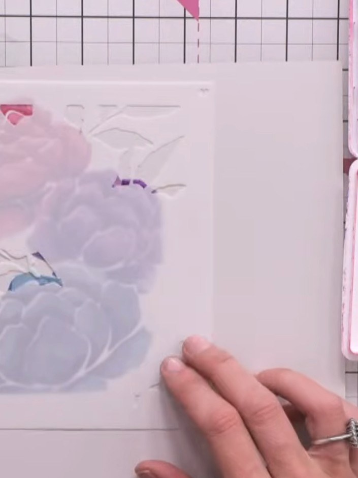 Step 6: Position the leafy stencil layers over your card and apply light teal ink using a blending tool, pressing gent