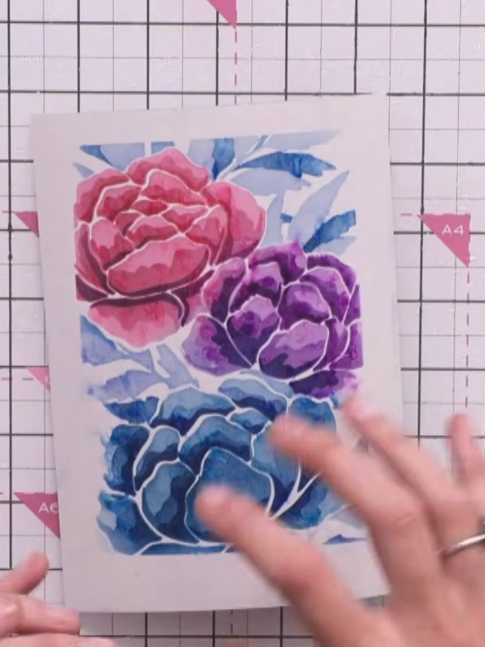 Step 8: Spray the finished stencil work with water and gently shake the card to loosen the design and create a waterco