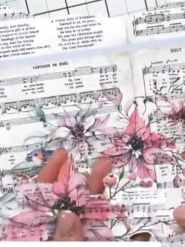 Step 1: Fussy cut a poinsettia design from the paper pad, carefully cutting around the petals and flower details.