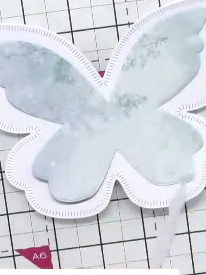 Step 3: Apply foam pads to the back of the die-cut butterfly poinsettia shape to create dimension. Position the foam p
