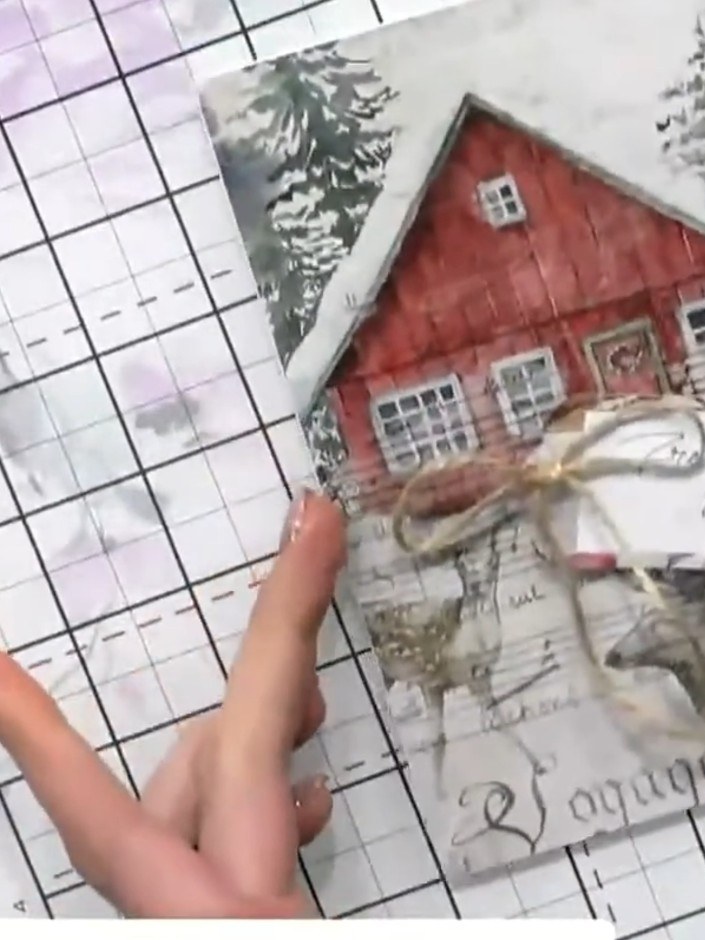 Step 1: Cut out a Christmas design element from the paper pad. Choose a festive image such as a house with trees and s