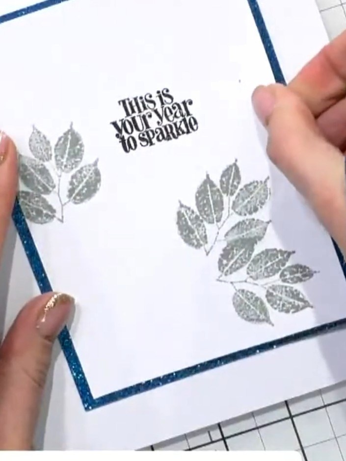 Step 3: Layer the stamped leaf images on your card front. Position the black stamped leaves first, then add the grey s