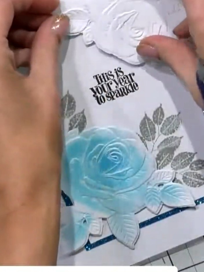 Step 7: If desired, trim away sections of the white embossed corner rose with scissors to change its format and create