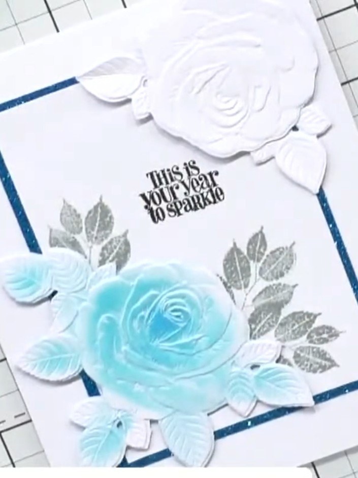 Step 8: Add sparkle or additional embellishments to complete your card. The finished design features turquoise waterco