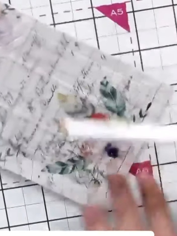 Step 4: Remove the embossed paper from the folder and inspect the raised window design. You can see the floral and scr