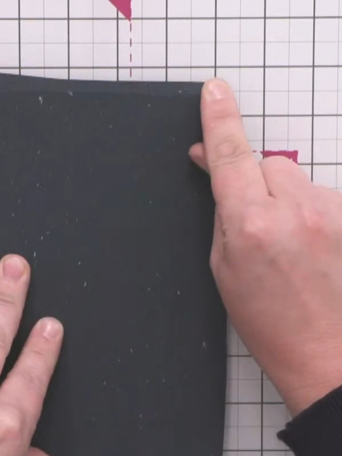 Step 4: Run your finger down each edge of the black card to create a crease line showing where the card underneath sit