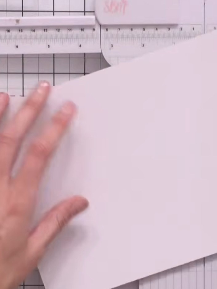 Step 3: Place both pieces of white cardstock in your score tool and score at 3/4 inch intervals all the way around eac