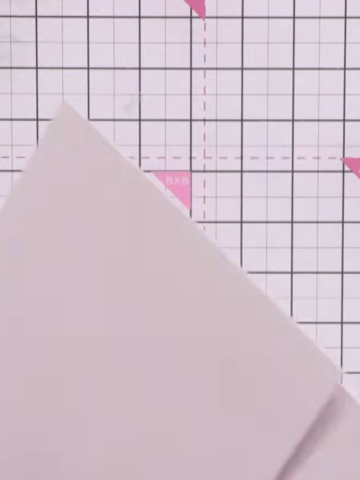Step 4: Cut diagonally into each corner at the score lines to create small triangles, stopping just before the scored 