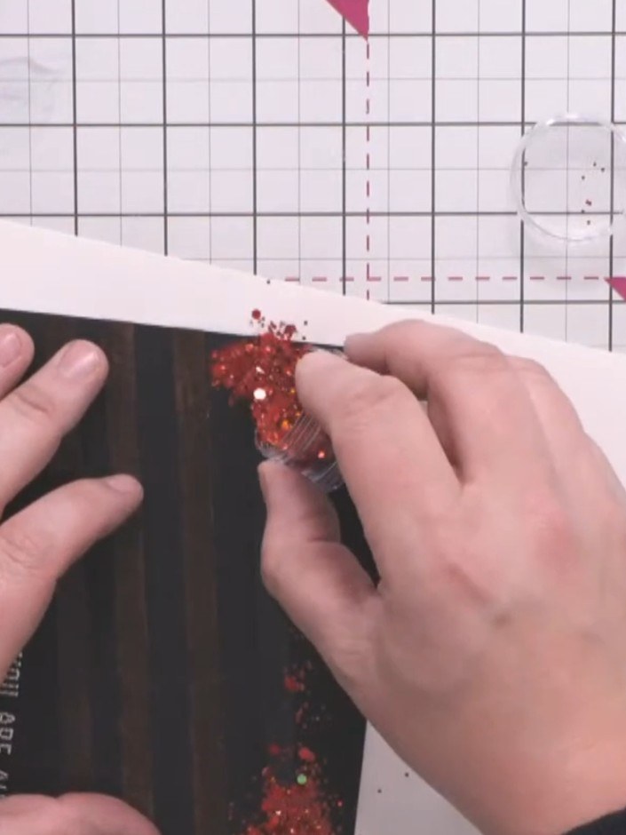 Passo 10: Lift one strip of double-sided tape at a time and sprinkle red glitter over it. Tap off the excess glitter ont