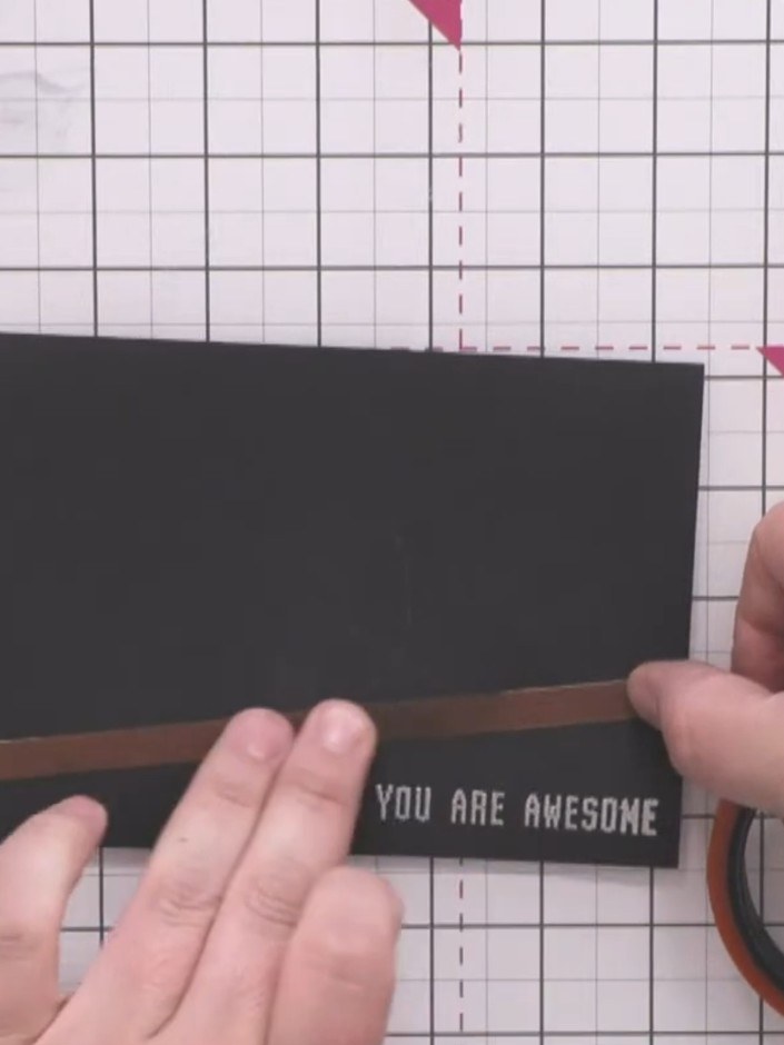 Passo 8: Apply silver embossing powder to the sentiment on the black card. Heat the embossing powder with a heat tool t