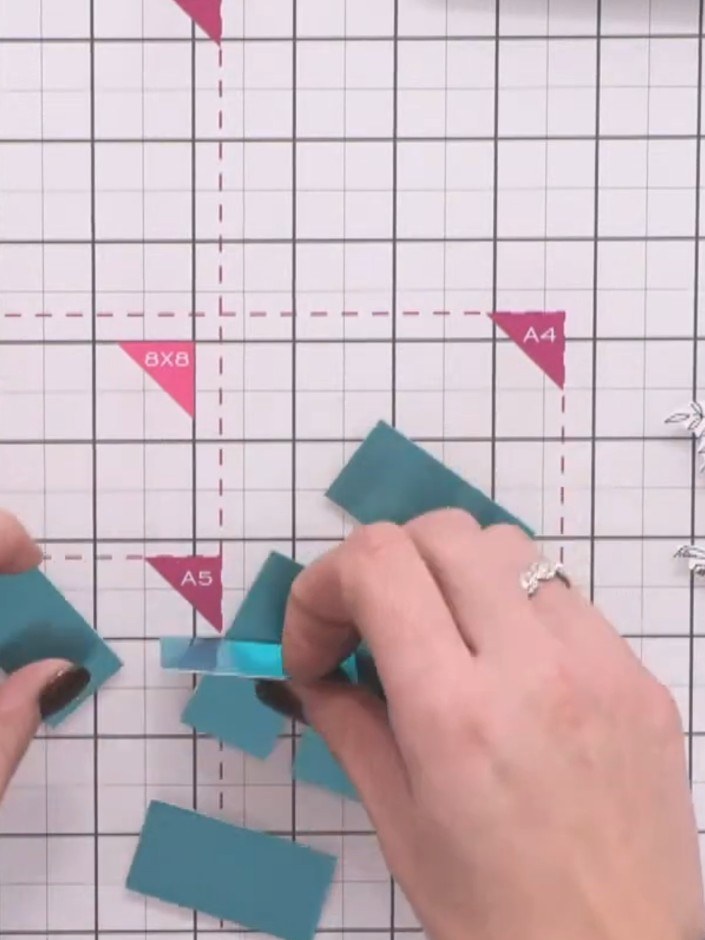 Passo 4: Cut your teal cardstock off-cuts into strips approximately one inch wide and varying lengths to create decorat