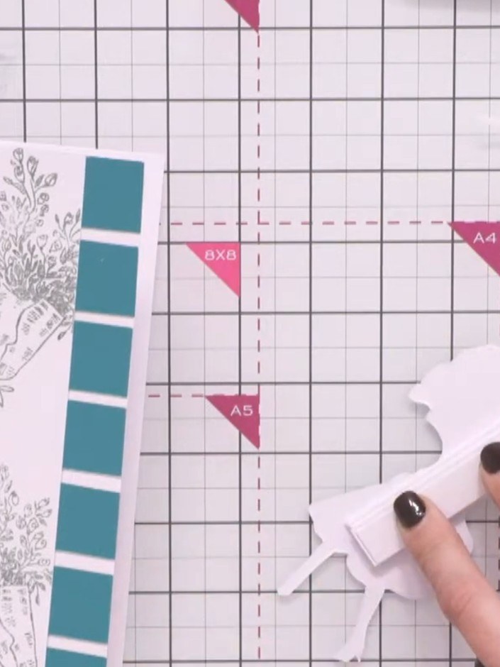 Passo 8: Cut small wedges from spare white cardstock to use as 3D padding. Layer these wedges behind the bouquet and ba