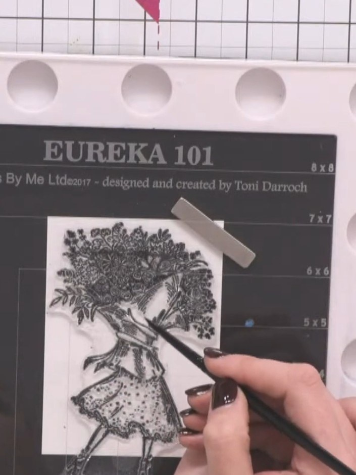 Step 1: Stamp the lady figure in black ink onto your dried bubble background, positioning her so the bubbles remain vi